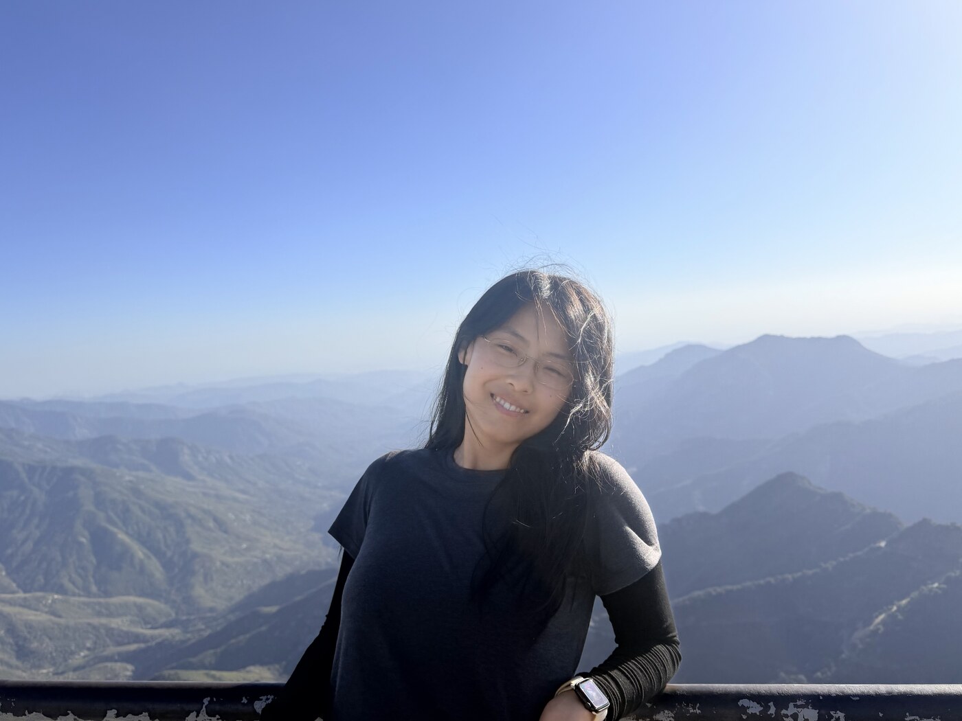 Chenchen smiling on a mountain overlook